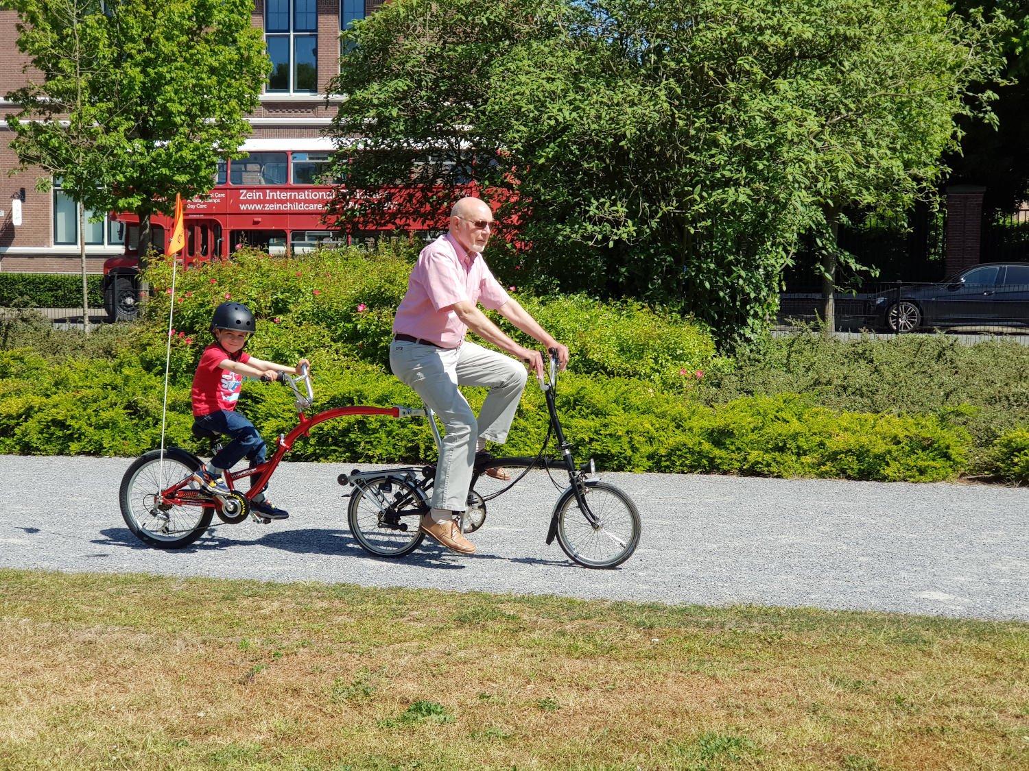 brompton and tagalong-web man on bike towing a child